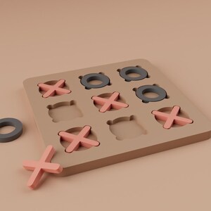 K&ouml;nnte beinhalten: Ein h&ouml;lzernes Tic-Tac-Toe-Spiel mit einem beigen Brett und rosa X'en. Die O's sind dunkelgraue Ringe. Ein O und ein X sind vom Brett getrennt. Ein klassisches Spiel f&uuml;r Kinder und Erwachsene.