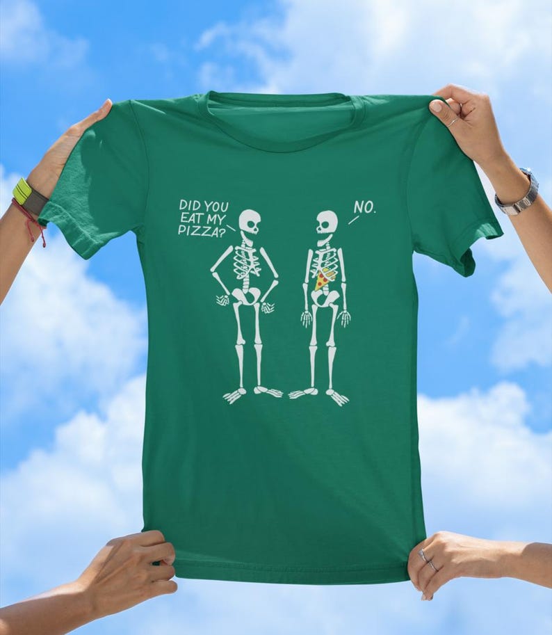 May include: A green t-shirt with a funny skeleton graphic. The text on the shirt reads "Did you eat my pizza?" and "No."