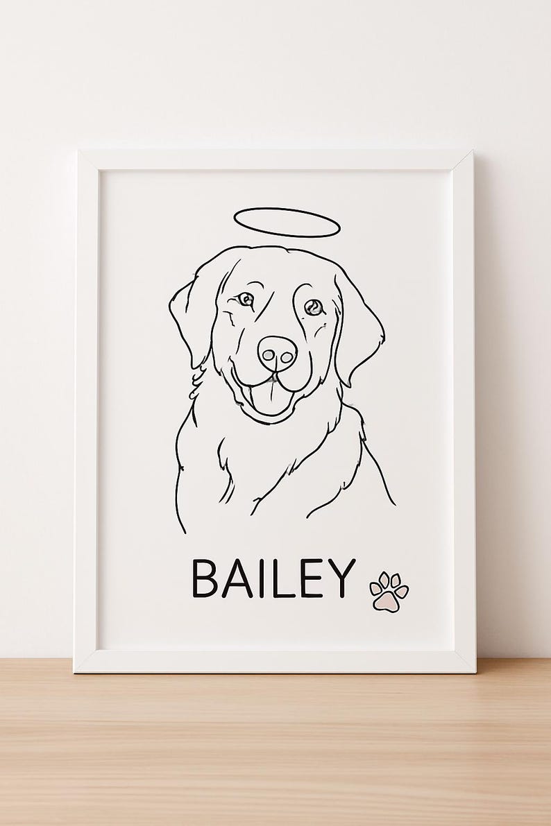 May include: A framed black and white line drawing of a dog with a halo above its head. The dog's name, "BAILEY," is printed below the image, along with a paw print. The artwork is displayed in a white frame.