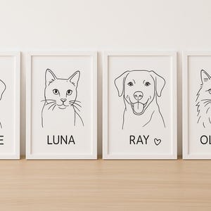 May include: Four framed line art prints featuring pet portraits. The prints showcase a dog with a halo, a cat, a dog with a heart, and a cat with a paw print. Each print has the pet's name in a simple font below the image.