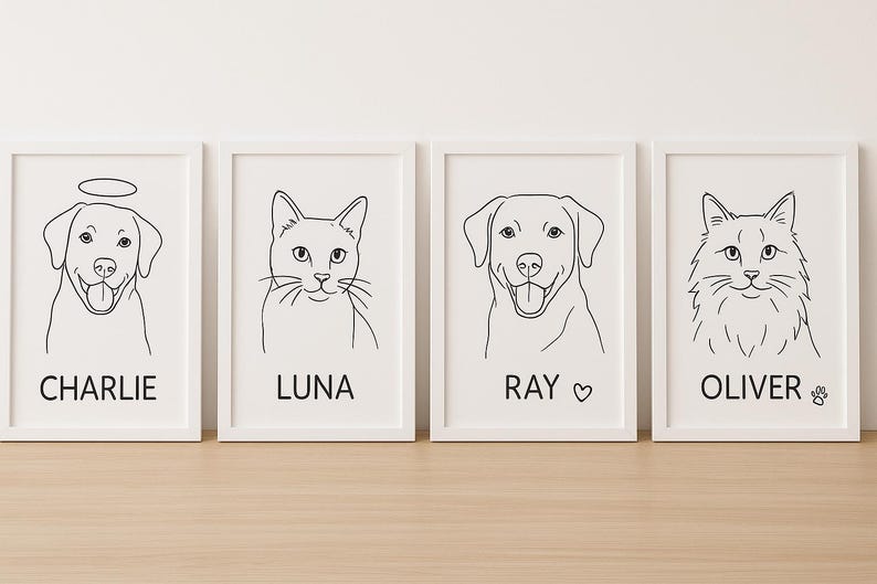 May include: Four framed line art prints featuring pet portraits. The prints showcase a dog with a halo, a cat, a dog with a heart, and a cat with a paw print. Each print has the pet's name in a simple font below the image.