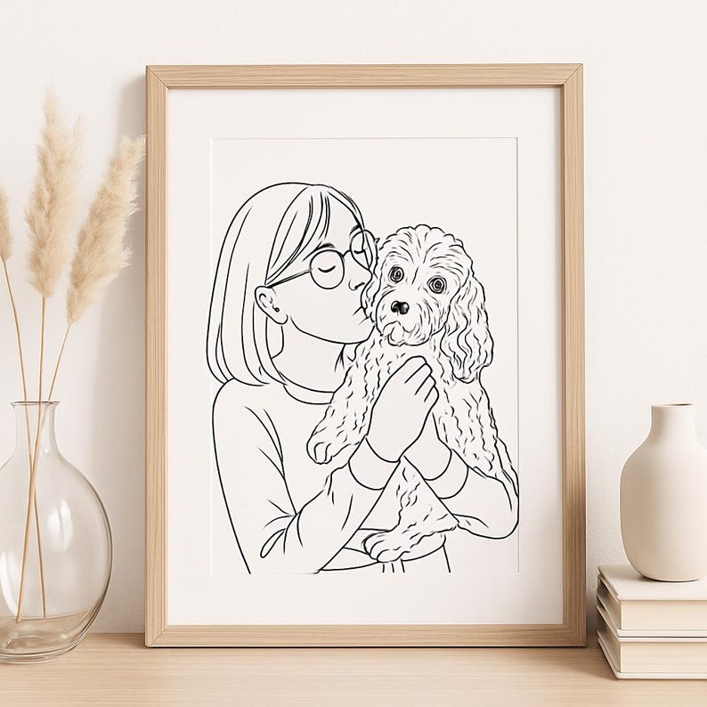 May include: A framed black and white line art print featuring a person kissing a dog. The person is wearing glasses and a long-sleeved shirt. The dog has curly fur. The frame is light brown.