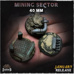 May include: Three miniature terrain bases for tabletop gaming. The bases are round and feature industrial and rocky textures, with a pipe, metal grate, and other details. The text "MINING SECTOR" and "40 MM" are visible. The text "JANUARY RELEASE" is also visible.