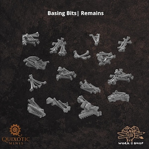 May include: A collection of miniature grey bone fragments and skeletal remains labeled Basing Bits | Remains. These small, unpainted plastic components are arranged in various clusters, featuring individual limb bones, rib sections, and skulls.