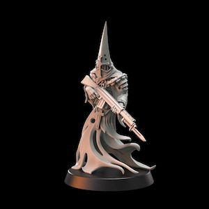 May include: A gray figurine of a hooded figure holding a rifle. The figure wears a tall, pointed hood and a long, flowing robe. The rifle is held at the ready, and the figure stands on a black base. The overall design has a fantasy or sci-fi theme.