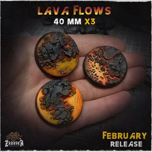 May include: Three 40mm round bases with a lava flow design. The bases have a textured surface with orange, yellow, and black colours, simulating hot lava and cooled rock. The text "LAVA FLOWS 40 MM X3" and "FEBRUARY RELEASE" are visible.