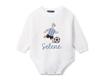 May include: A white long-sleeved knit bodysuit featuring a graphic of a goose wearing a light blue and white striped soccer jersey and black shorts, kicking a soccer ball. The name Selene is printed in blue script lettering below the graphic.