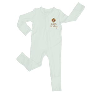 May include: A light green, one-piece baby sleeper with long sleeves and attached feet. The sleeper has a full-length zipper and a small graphic of a turkey wearing a hat with the words "little turkey" printed below the turkey.