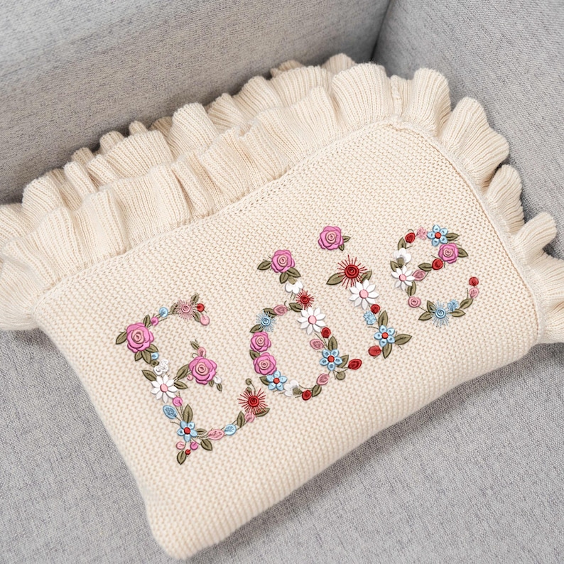 Personalized embroidered baby blanket with boho floral design, perfect for newborn girls. Soft and cozy knit baby blanket makes a beautiful baby shower gift, keepsake, or first birthday present. Custom name embroidery adds a personal touch to this charming and stylish floral baby blanket.