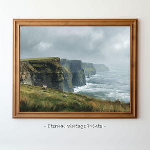 Może przedstawiać: Oprawiony wydruk krajobrazu nadmorskiego z dramatycznymi klifami i oceanem pod zachmurzonym niebem. Grafika przedstawia zielone klify, rozbijające się fale i dwie owce pasące się na trawiastym terenie. Rama jest drewniana. Tekst "- Eternal Vintage Prints -" znajduje się na dole.