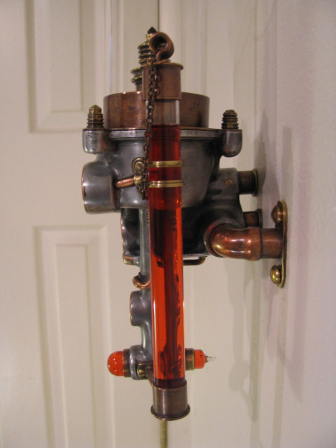 Wall mounted oil lamp made with recycled metals and glass. Etsy