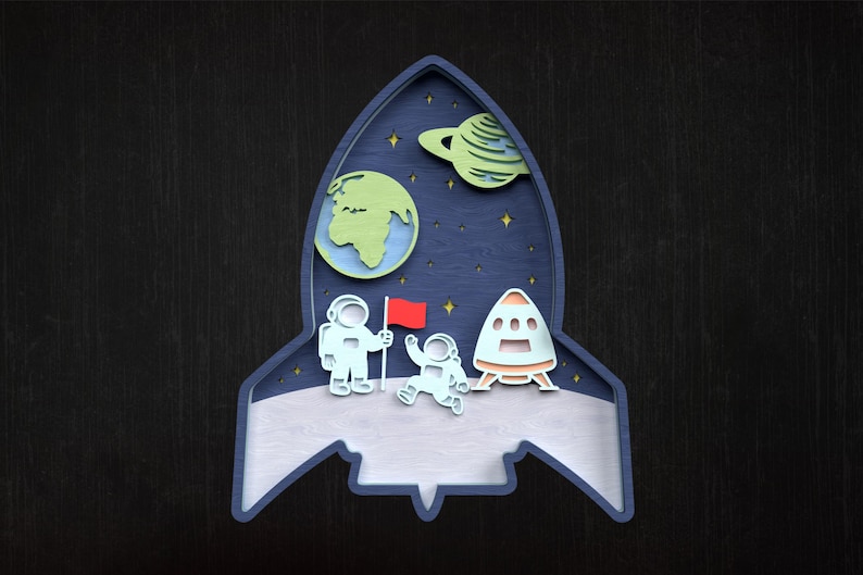 May include: A wooden artwork in the shape of a rocket. The design features astronauts, planets, and stars against a dark blue backdrop. The astronauts are holding a red flag, and a spaceship is also present.