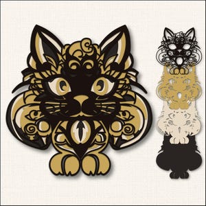 May include: A decorative cat design in black, gold, and cream. The cat has large eyes and intricate patterns. A stacked cat design in black, gold, and cream is also shown. The cat design is suitable for home decor.