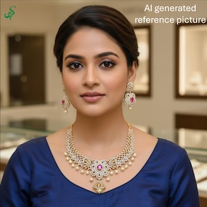 May include: A woman wearing a gold-toned necklace, earrings, and a blue top. The jewelry features clear stones, pink gemstones, and small pearls. The necklace has a floral design with a central pink stone and a pendant. The earrings match the necklace design.