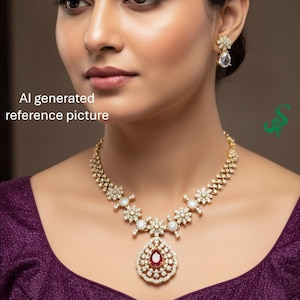 May include: A gold-toned necklace and matching earrings set. The necklace features a central pendant with a teardrop-shaped ruby surrounded by small, clear stones. The earrings have a similar design. The image also includes the text "AI generated reference picture."