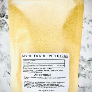 May include: A tan pouch of Liv's Tea's 'N Things capsules. The label states the product contains organic ashwagandha root and vegan capsules. Directions advise taking one capsule daily with an 237 ml drink and a meal.
