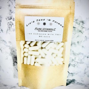 May include: A kraft paper pouch with a clear window displaying numerous white capsules. The pouch has a label that reads "Liv's Teas 'n Things" and "Pure Vitamin C (as Ascorbic Acid)". The label also indicates 100 capsules with 750+ mg each, with a best-by date of January 2028.
