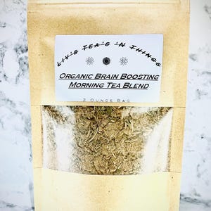 May include: A brown paper bag with a white label that reads "Liv's Tea's 'N Things" and "Organic Brain Boosting Morning Tea Blend" with a 2 ounce bag of loose leaf tea inside.