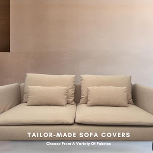May include: A beige sofa with two pillows on each side. The sofa has a light brown fabric cover and is sitting on a light pink wall. The text "TAILOR-MADE SOFA COVERS" is displayed below the sofa, with the tagline "Choose From A Variety Of Fabrics".