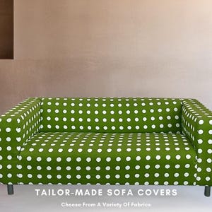May include: A green sofa cover with white polka dots. The cover is made for a two-seater sofa. "Tailor-Made Sofa Covers. Choose From A Variety Of Fabrics." is printed below the sofa.