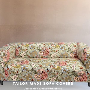 May include: A floral patterned sofa cover in shades of green, red, and white. The text "TAILOR-MADE SOFA COVERS" and "Choose From A Variety Of Fabrics" is displayed below the sofa.