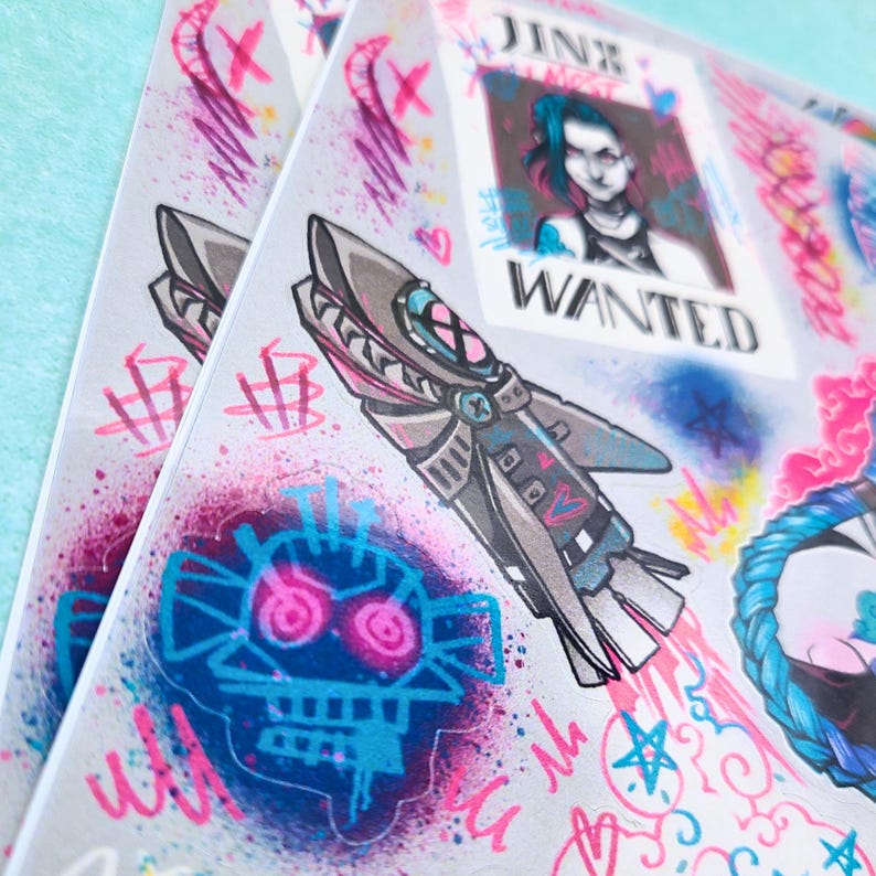 May include: A set of colorful stickers featuring a character from the video game League of Legends. The stickers feature a character named Jinx, a rocket, and a skull with glowing eyes. The stickers are printed on a white background with a holographic finish.