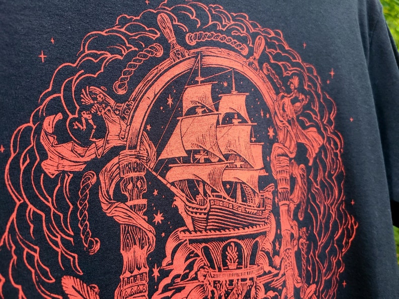 A closeup of the red pirate illustration shows the pirate ship, ropes, and the helm of the ship.