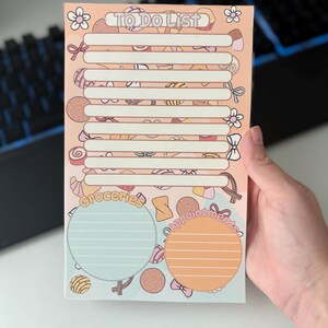 May include: A pastel-colored To Do List notepad with a candy theme. The notepad features a header that reads "TO DO LIST" and includes lined sections for tasks, plus sections for "Groceries" and "Appointments". The background is decorated with candy illustrations.