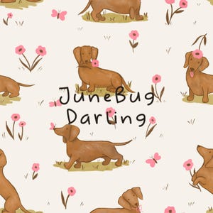 May include: A repeating pattern featuring brown dachshunds, pink flowers, and butterflies on a cream background. The text "June Bug Darling" is also included in the design. The illustration has a whimsical, hand-drawn style.
