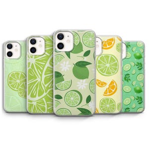 May include: A collection of five phone cases with vibrant fruit designs. The cases feature patterns of green limes, lime slices, and orange slices on a variety of backgrounds, including light green and yellow. The cases are made of a clear, protective material.