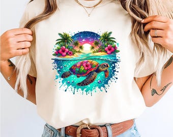 May include: Cream-colored t-shirt featuring a vibrant, colorful graphic of a sea turtle swimming underwater. The design includes a tropical beach scene with palm trees, pink flowers, and a sunset. The turtle's shell is adorned with floral patterns.