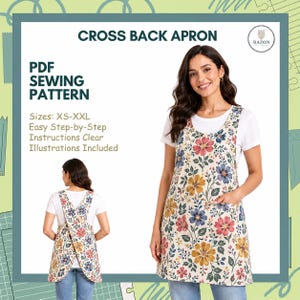 May include: A cross-back apron with a floral pattern, worn over a white t-shirt and jeans. The apron has a pocket and a cream background with colorful flowers. The image also shows the text "CROSS BACK APRON" and "PDF SEWING PATTERN".
