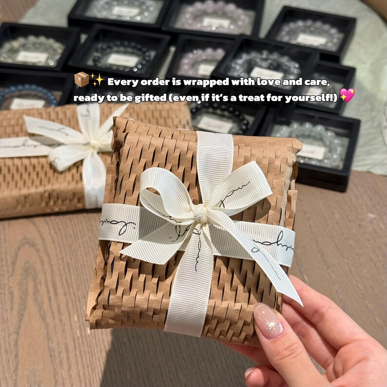 May include: A gift box wrapped in brown paper and tied with a white ribbon. The ribbon has the word "love" printed on it. The image text reads: "Every order is wrapped with love and care, ready to be gifted (even if it's a treat for yourself!)"