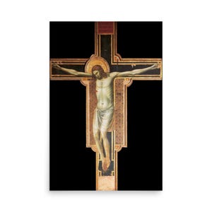 May include: A painted wooden crucifix featuring a central figure of a person with long brown hair, wearing a white loincloth, with arms outstretched against a black background. The cross has gold-toned decorative borders and a red rectangular panel.