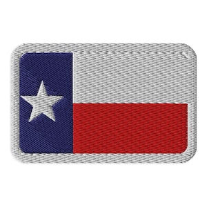 May include: A rectangular embroidered patch featuring the Texas state flag design. The patch has a vertical blue stripe on the left side with a single white five-pointed star, and horizontal white and red stripes on the right side with a border.