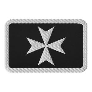 May include: Embroidered patch featuring a white Maltese cross on a black background. The patch has a rectangular shape with a gray border. The cross design is a symbol of the Knights of Malta.