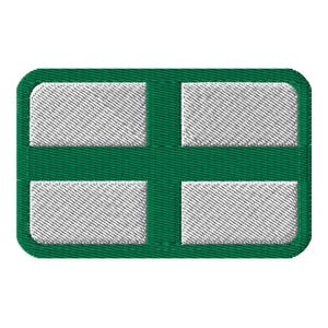 May include: Embroidered patch featuring a green border and a white cross design. The cross is divided into four rectangular sections, each filled with a textured, white thread. The patch has rounded corners.