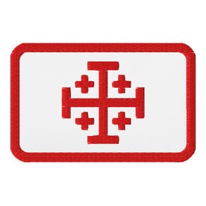 May include: Embroidered patch featuring the Jerusalem cross, a heraldic symbol. The design has a red border and a white background. The cross is red and centered on the patch.