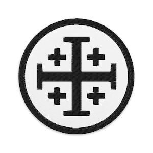 May include: Circular embroidered patch with a black Jerusalem cross on a white background. The patch has a black border. The design is a religious symbol, suitable for attaching to clothing or bags.