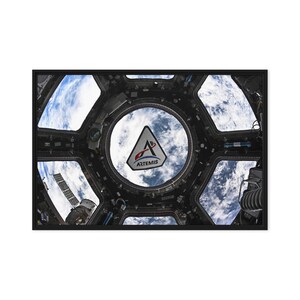 May include: A photograph of Earth seen through a spacecraft window, displaying the planet's clouds. The Artemis logo is in the centre of the window, with the spacecraft's interior visible. The image is framed in black.