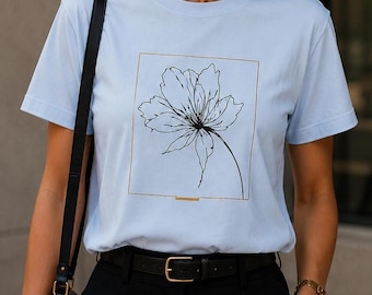 Camiseta minimalista con estampado botánico lineal y formas abstractas. Top informal.