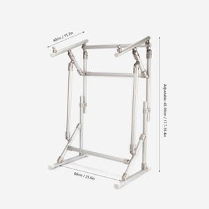 May include: A silver metal adjustable stand featuring a frame with multiple joints and support bars. Dimensions are labeled as 40cm/15.7in wide, 60cm/23.6in deep, and an adjustable height ranging from 45-90cm/17.7-35.4in for the overall structure.