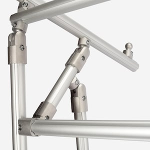 May include: A modular silver aluminum frame structure featuring cylindrical tubes connected by adjustable metal joints and fasteners. The assembly includes multiple intersecting bars and a small spherical attachment point on one of the top rails.