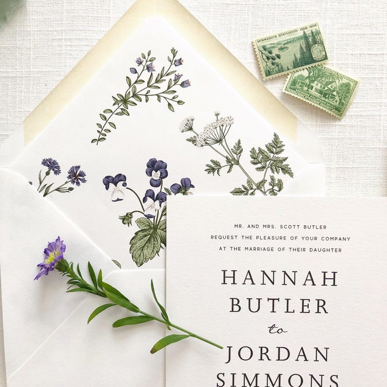 May include: A white wedding invitation with black text announcing the marriage of Hannah Butler to Jordan Simmons. The invitation is decorated with a floral pattern in shades of green and purple.