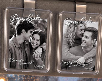 May include: Two rectangular clear acrylic car visor clips featuring black and white photographs of couples. The left clip reads Drive Safe... I love you so much! Benyl. The right clip reads Drive Safe... Every mile, I'm with you! Cathy.