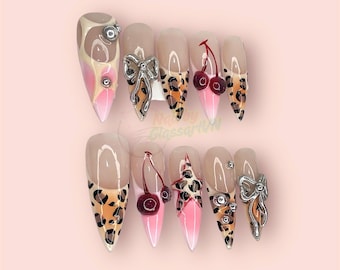 Luipaardkersenstiletto pers op de nagels: 3D-nagelkunst met strikbedel