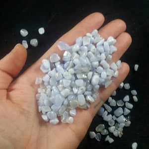 May include: A handful of light blue and white tumbled blue lace agate stones. The stones are smooth and polished, and they are perfect for use in crafts, jewelry, or meditation.