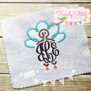 May include: Embroidered turkey design with teal and brown accents on a white background. The turkey features a monogram and is part of a design with the text "Trendy Stitch Designs".