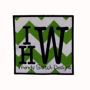 Könnte beinhalten: Grüner und weißer Chevron-Stoff mit den Buchstaben "I W" in schwarzer umrandeter Schrift. Der Text "Trendy Stitch Designs" befindet sich unter den Buchstaben.