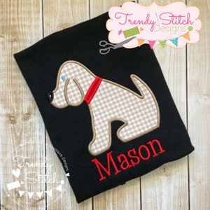 May include: Black t-shirt with a beige and white gingham dog applique and the name "Mason" embroidered in red.